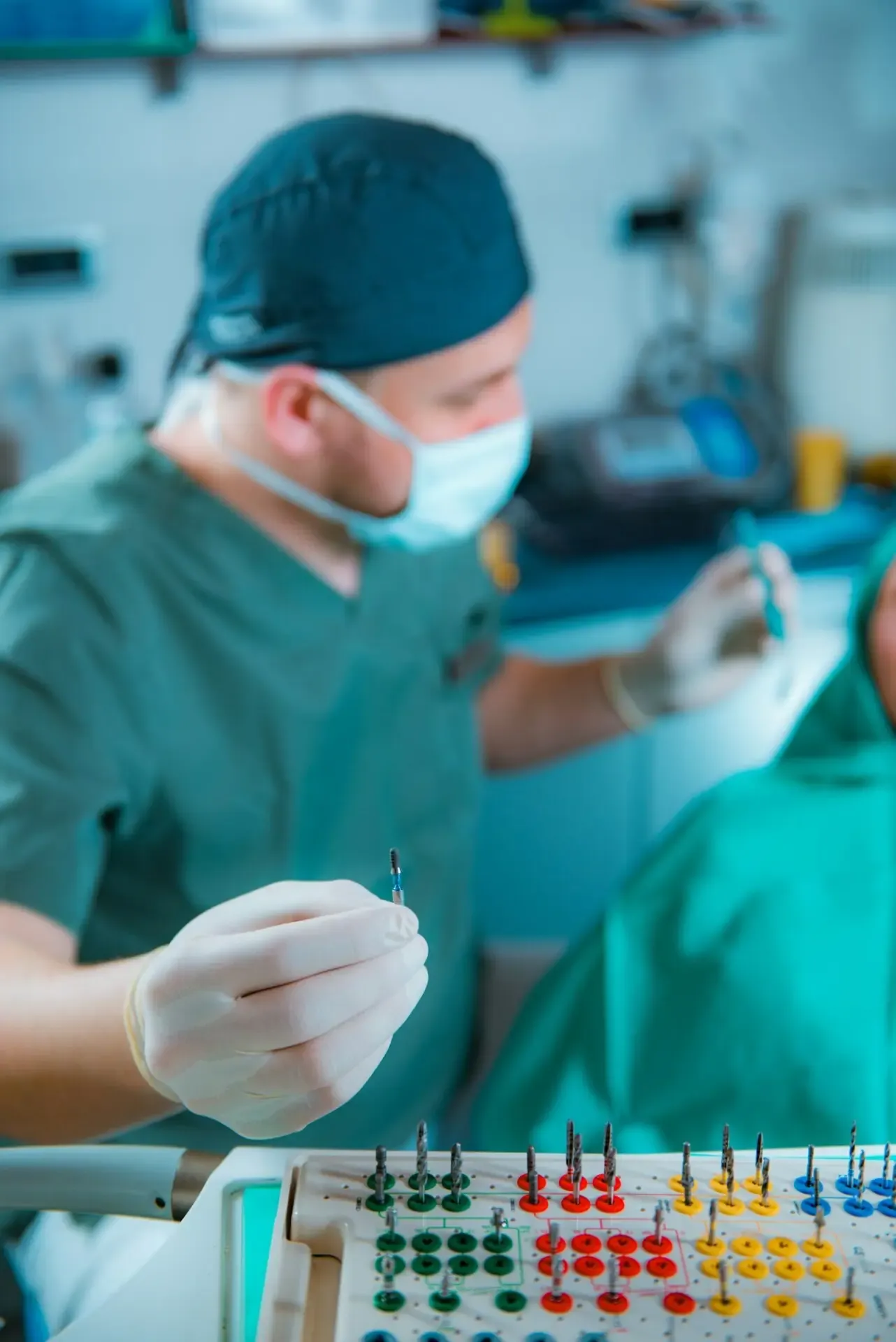 A dentist preparing tools for a dental implant installation