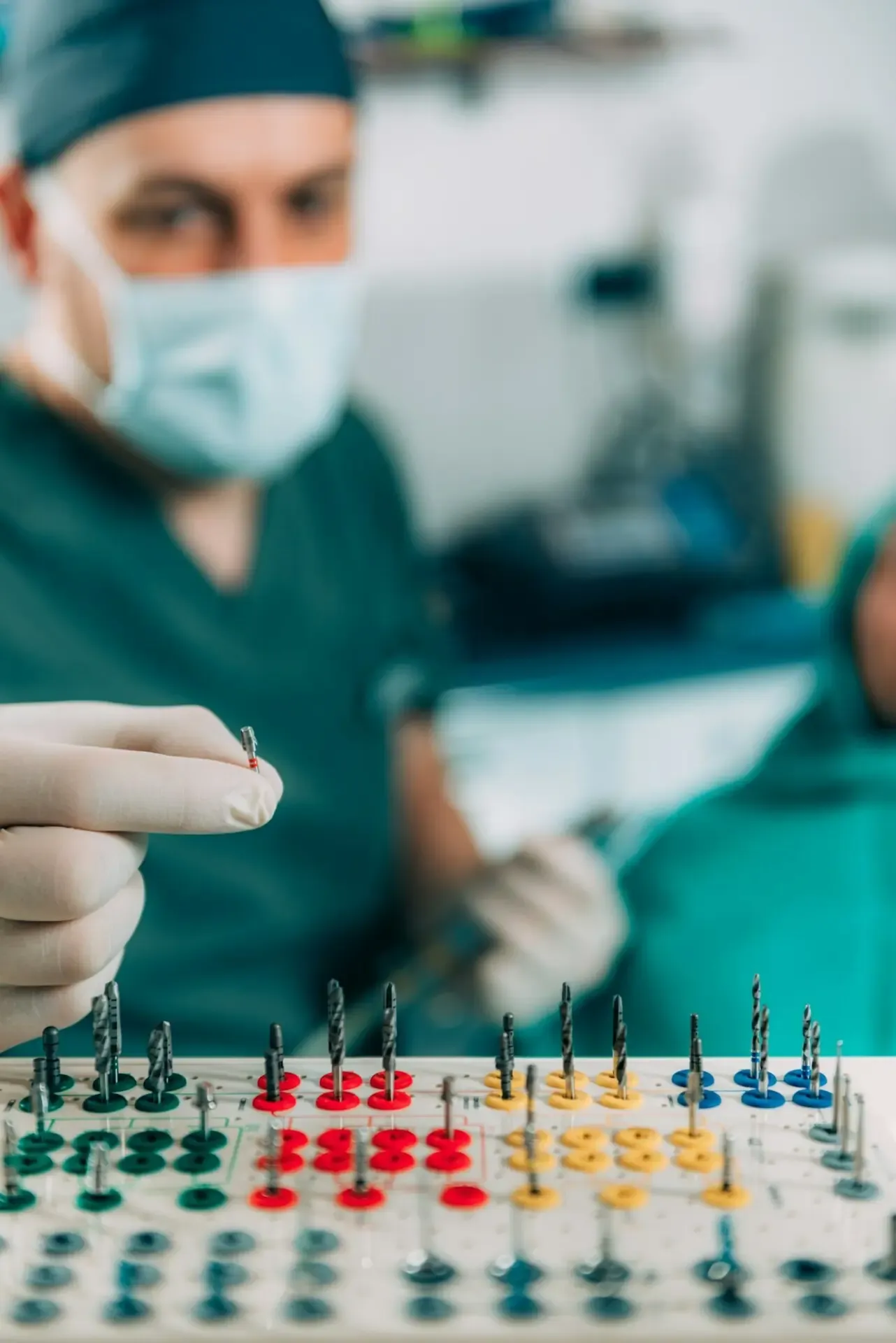 A dentist holding a tool for installing dental implants