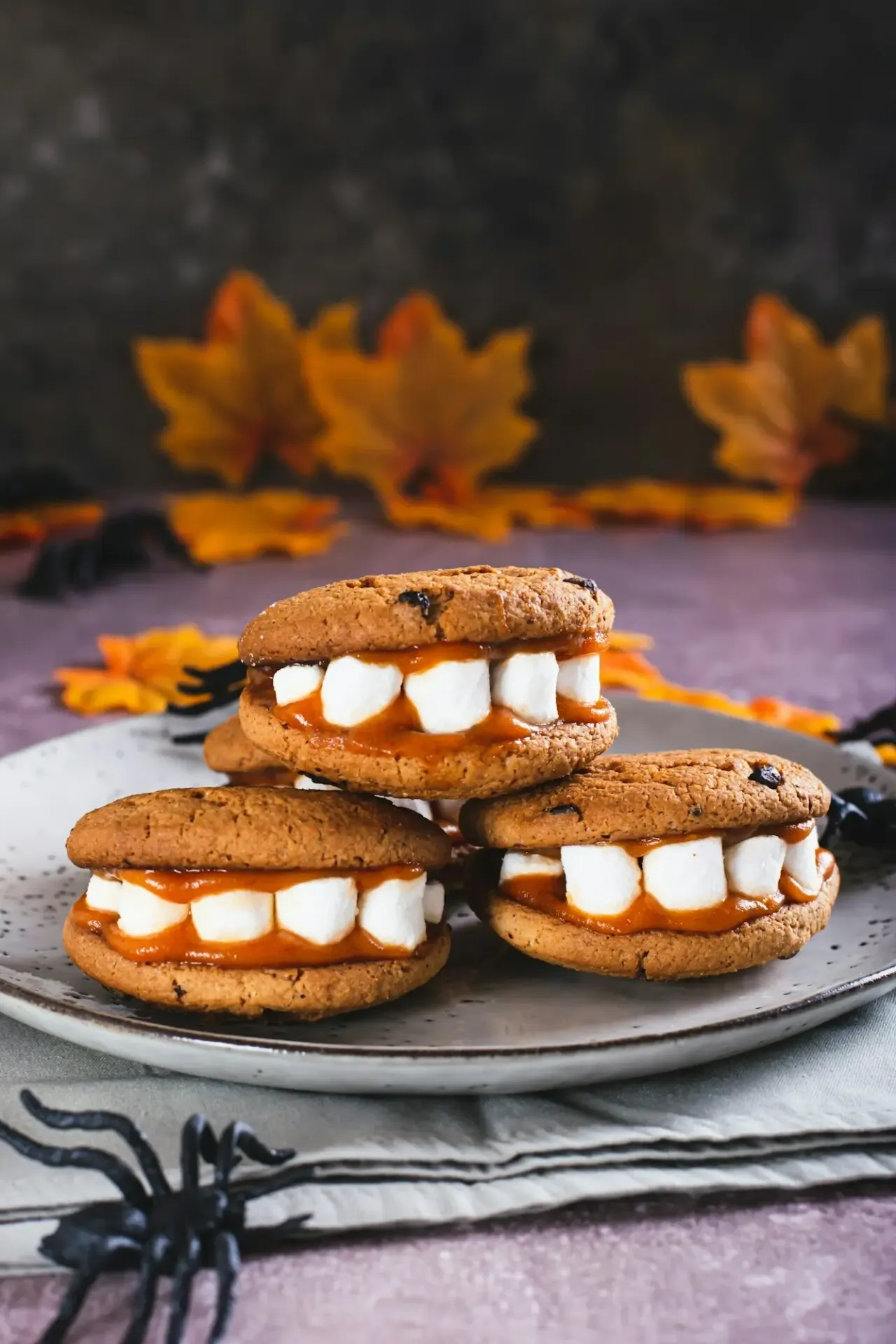 Gingerbread cookies with marshmallow teeth on a plate