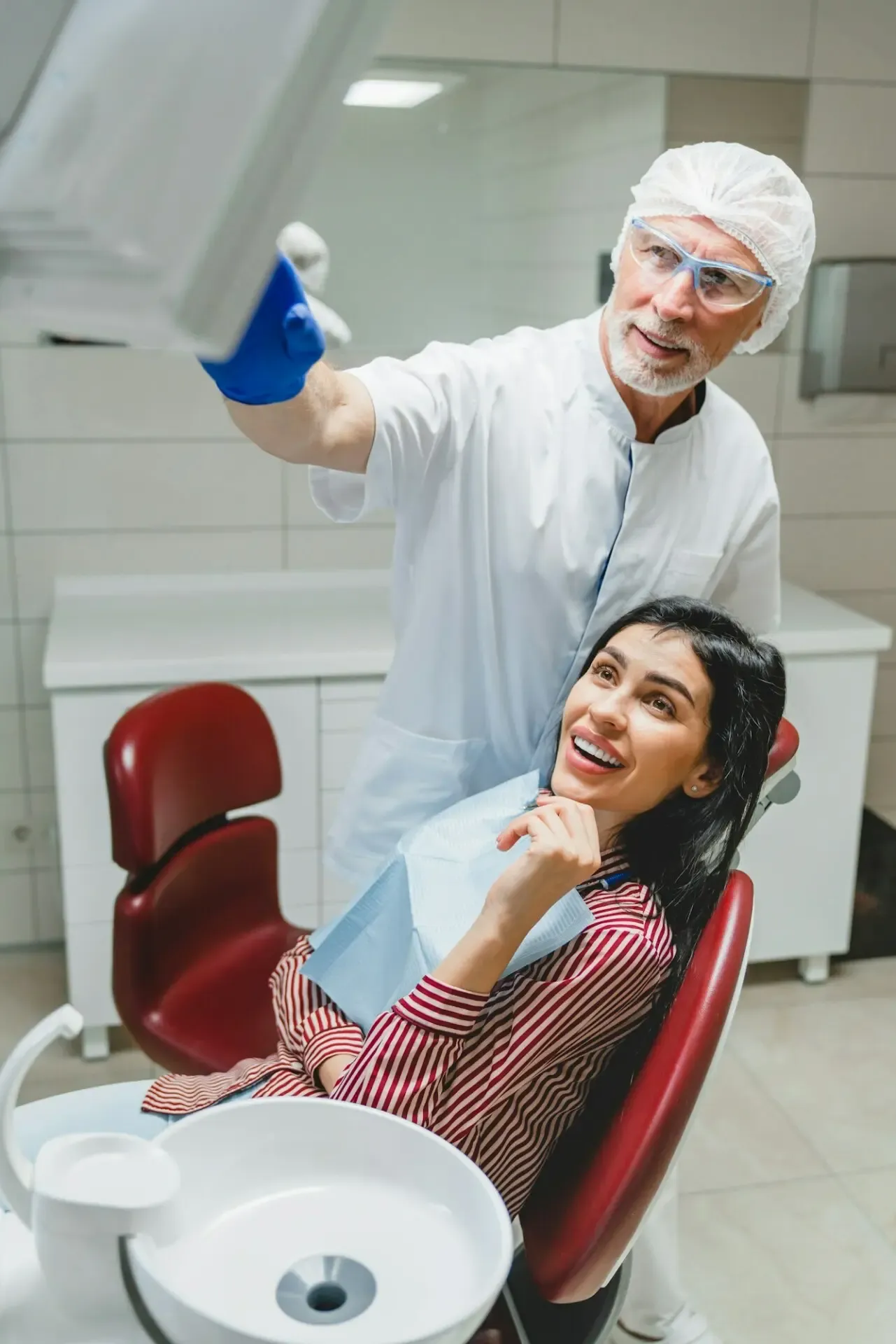 A dentist showing a patient an x-ray photo while applying veneers