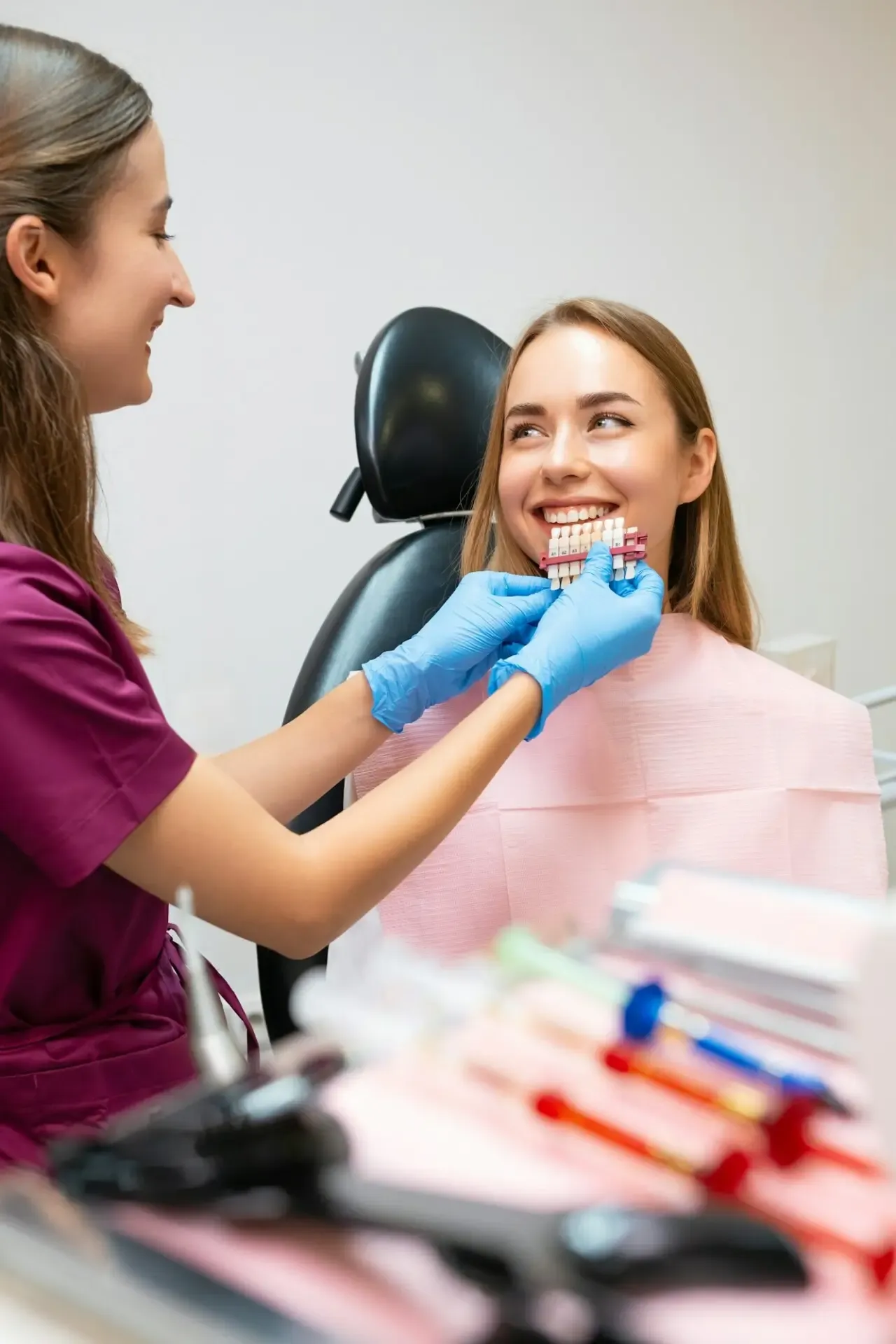 A dentist choosing the ideal shades of white to enhance a patient's smile